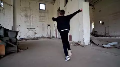 AI Video from prompt: A boy in black and a mask walks around an abando