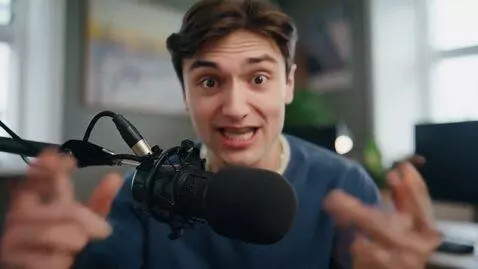 AI Video from prompt: A young, attractive man in a modern podcast stud