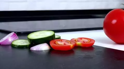 AI Video from prompt: big red tomato eats cucumber with onion