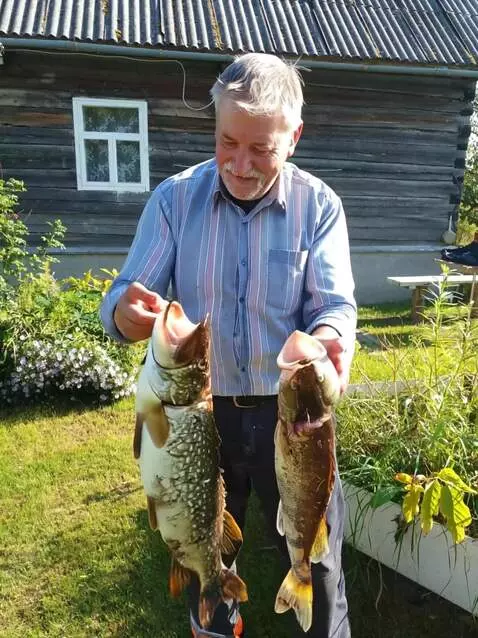 AI Video from prompt: A man throws two fish into the air and then catc