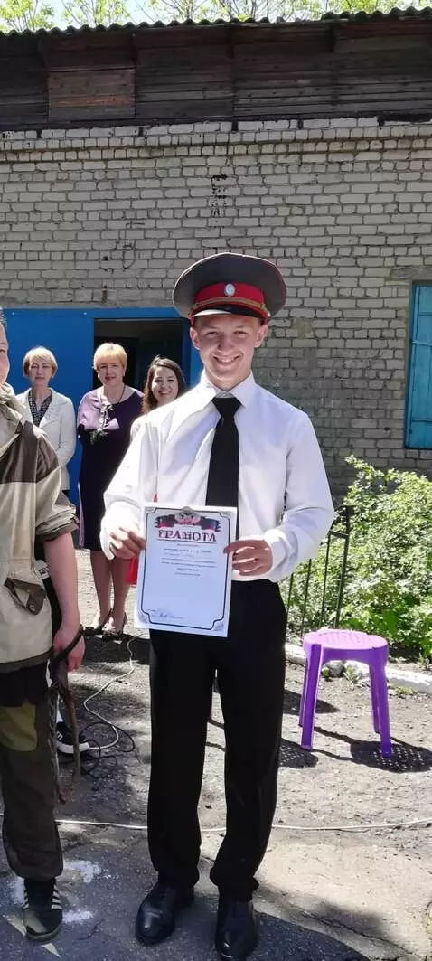 AI Video from prompt: He smiles and shows his diploma.