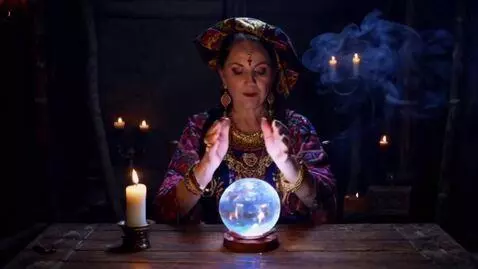 AI Video from prompt: A mystical old gypsy woman sits at a wooden tabl