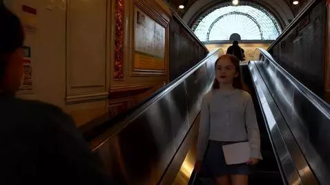 AI Video from prompt: Young lady approach Moscow metro station. She pa