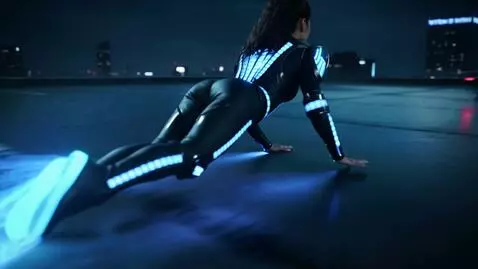 AI Video from prompt: A woman in an LED jumpsuit with slits at the sho