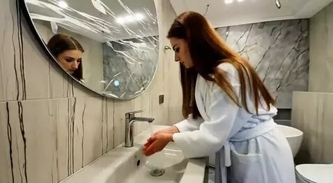 AI Video from prompt: the woman touches the handle of the mixer with h