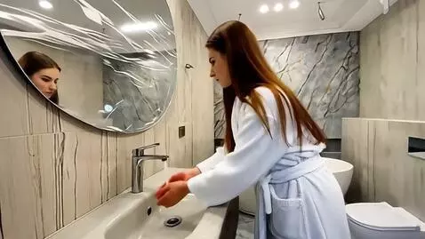 AI Video from prompt: the woman touches the handle of the mixer with h