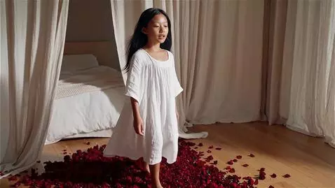 AI Video from prompt: A girl of walks on rose petals.   her skin shoul