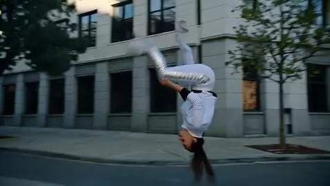 AI Video from prompt: A woman in a white tracksuit with metal inserts 