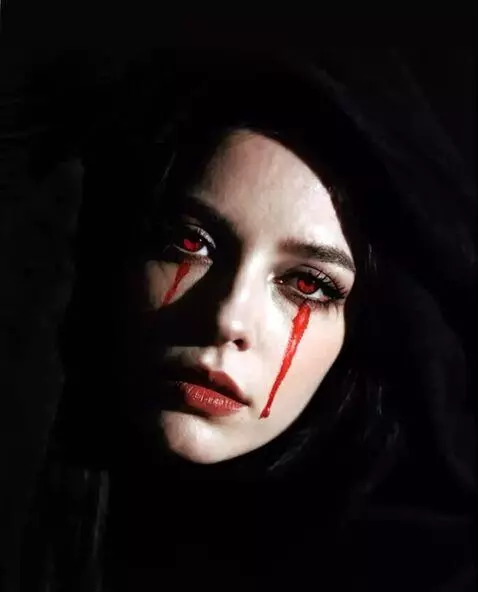 AI Video from prompt: Red tears are streaming down the woman's face.