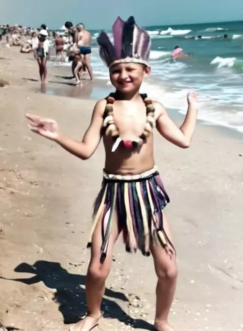 AI Video from prompt: A boy waves his arms at the camera and jumps. Be