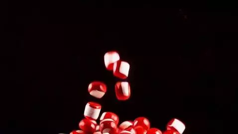 AI Video from prompt: generate a video of some red-white pills falling