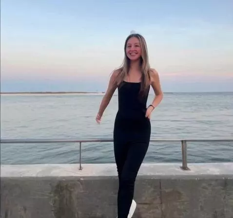 AI Video from prompt: teenage girl flying up and out of frame for a wh