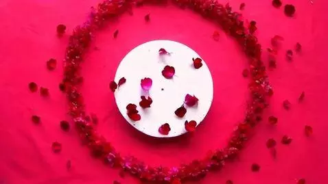 AI Video from prompt: A cascade of crimson petals swirls dynamically a