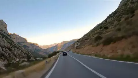 AI Video from prompt: a car driving on a mountain hill
