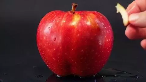 AI Video from prompt: A hyper-realistic video of a ripe red apple with