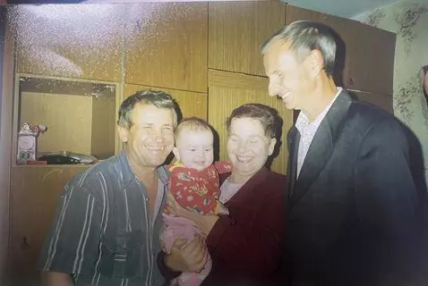 AI Video from prompt: They are smiling, hugging a child