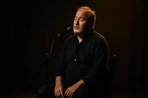 AI Video from prompt: A kind-looking middle-aged man (around 50 years 