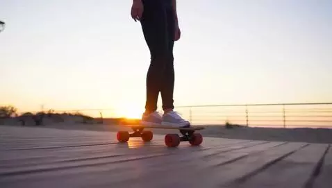 AI Video from prompt: woman on a one wheeled skateboard gliding down a