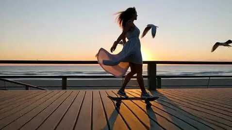 AI Video from prompt: woman on a one wheeled skateboard gliding down a