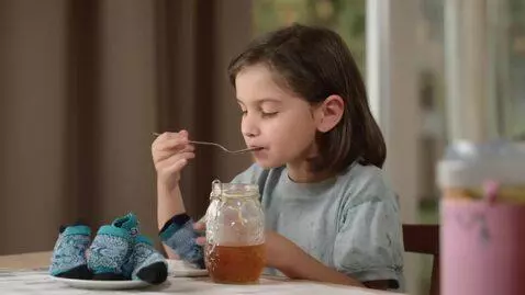 AI Video from prompt: Boy  eating socks with honey