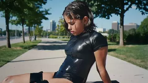 AI Video from prompt: Девушка лет 18 сидит на лавке и черной латексной