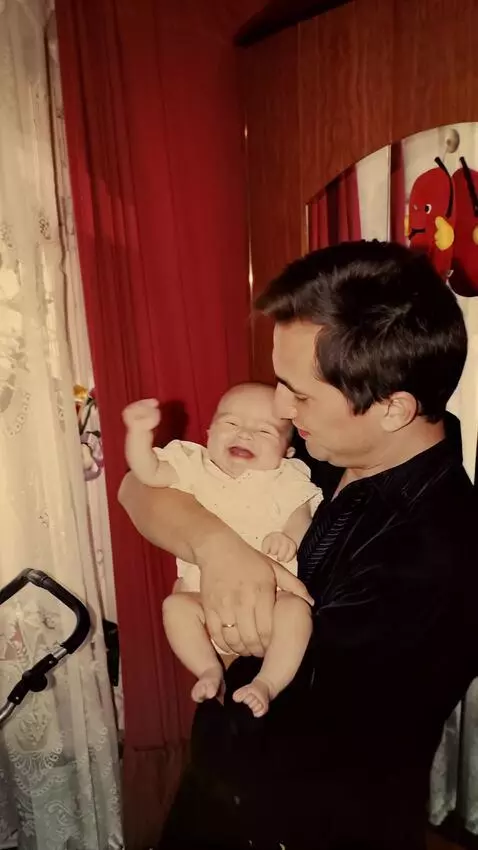 AI Video from prompt: The man gently and slowly rocks the baby in his 