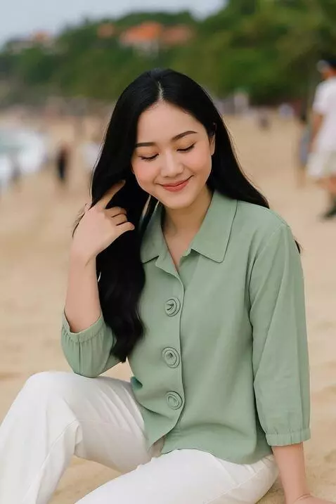 AI Video from prompt: The model sits elegantly on the shore, surrounde