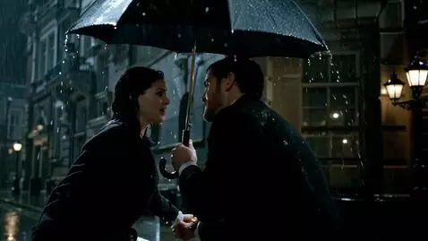 AI Video from prompt: Action (8s): Rain pours in a London street. Sher
