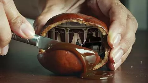 AI Video from prompt: Scene: Close-up of manicured female hands slicin