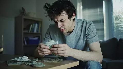 AI Video from prompt: A young man with disheveled dark brown hair is c