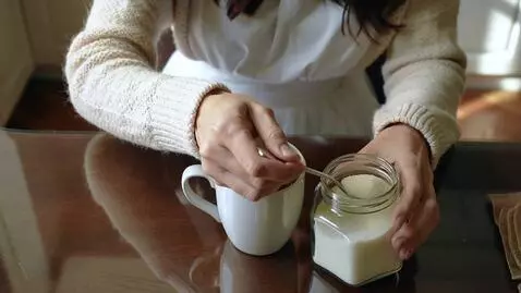 AI Video from prompt: A Russian woman puts a spoonful of sugar into a 