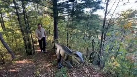 AI Video from prompt: a small dinosaur runs out from behind, and the m