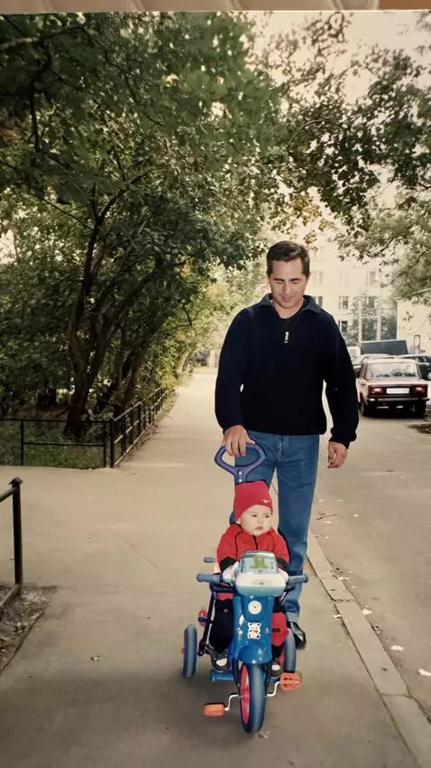 AI Video from prompt: A man is carefully riding a bicycle with a child