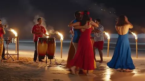 AI Video from prompt: A warm tropical night. The beach is lit by the l