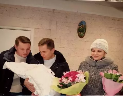 AI Video from prompt: A man holds a baby in his arms and gently rocks 