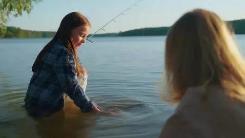 AI Video from prompt: make it look like this girl caught a fish in the