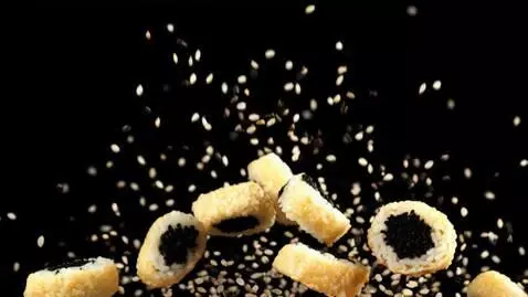 AI Video from prompt: The japanese rice rolls slowly fall on air on a 