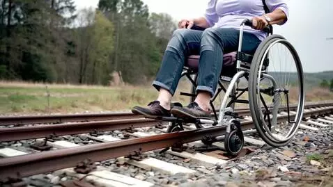 AI Video from prompt: Grandma rides a wheelchair on the tracks