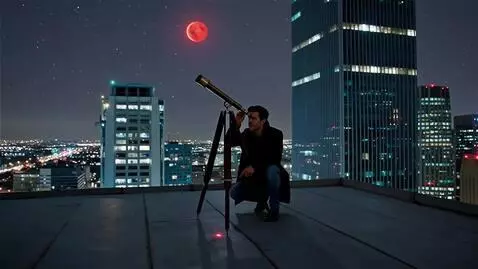 AI Video from prompt: A skyscraper roof. A guy points a telescope at M
