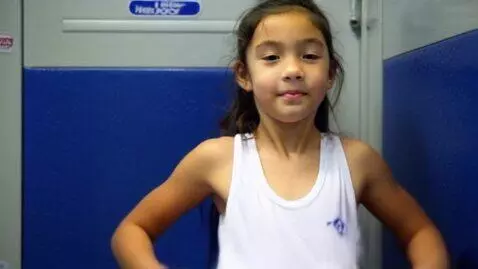 AI Video from prompt: 18 year old girl in locker room taking off shirt