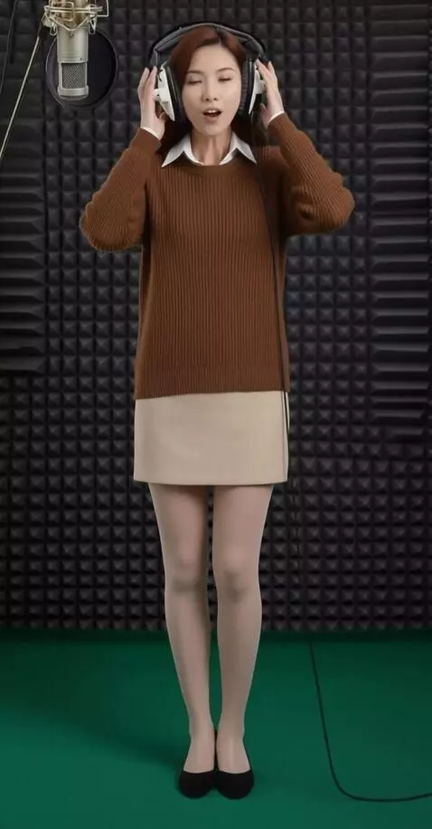 AI Video from prompt: a woman is actively singing while pressing headp