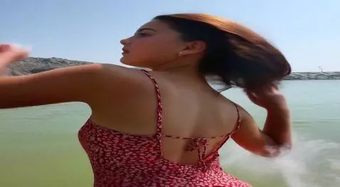 AI Video from prompt: the girl turns around and adjusts her hair beaut