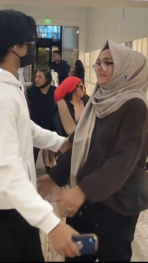 AI Video from prompt: woman quickly changes into a swimsuit, man leans