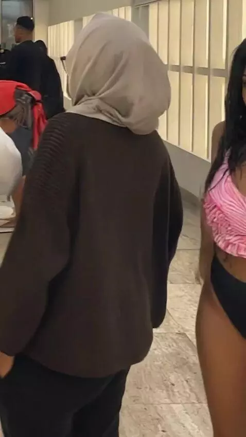 AI Video from prompt: woman changes her clothes and puts on a swimsuit