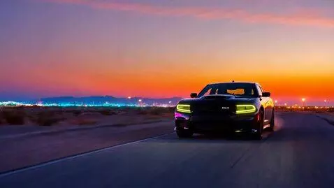 AI Video from prompt: A midnight-black 2025 Dodge Charger explodes int