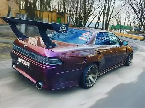 AI Video from prompt: A sleek, dark blue Toyota Mark 2 (JZX100) cruisi