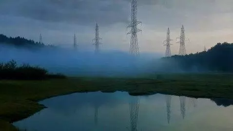 AI Video from prompt: Mist rolling over shallow ponds, electric towers