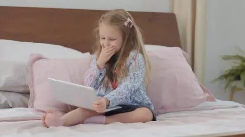 AI Video from prompt: The girl is sitting on the bed