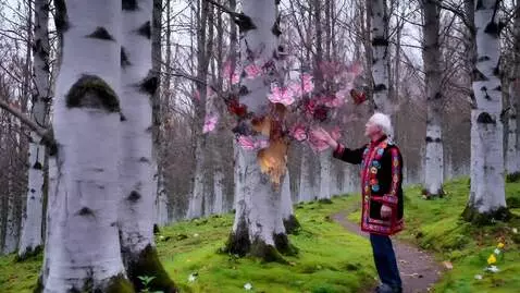 AI Video from prompt: An old man in an embroidered shirt walks along a
