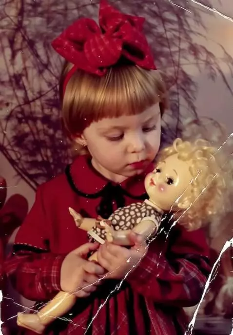AI Video from prompt: The girl is holding a doll in her arms, which sh